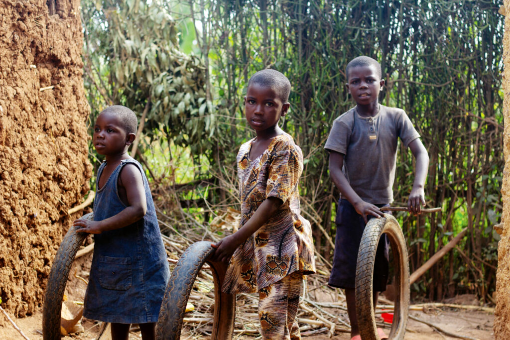 kids carrying tires