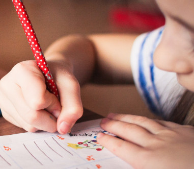 kid writing on paper